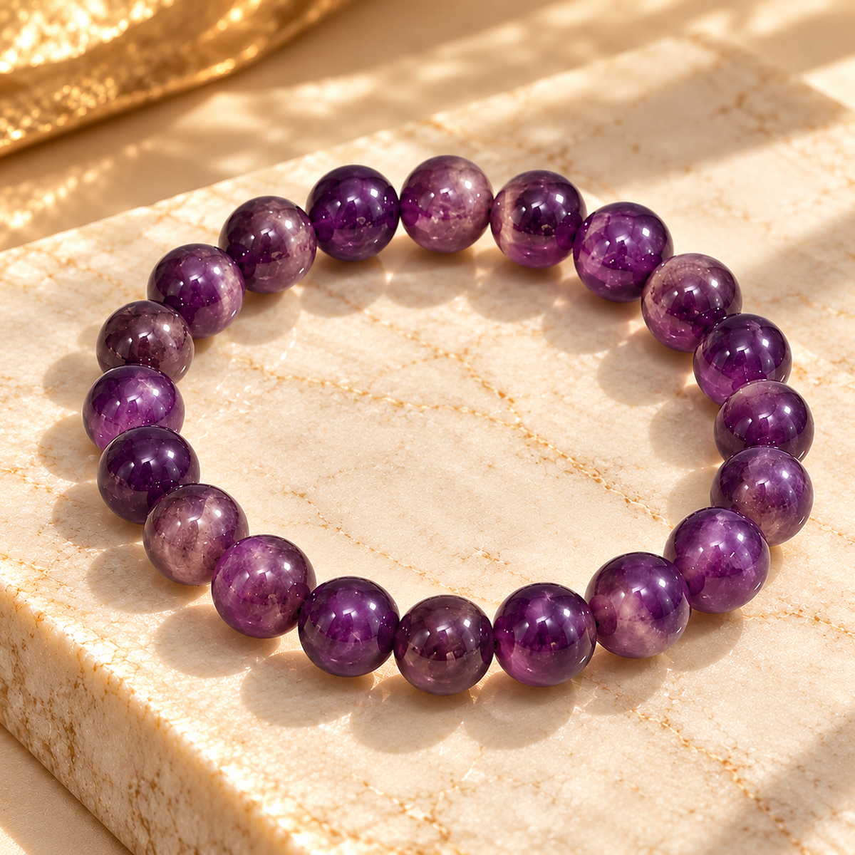 Amethyst bead bracelet resting on warm marble in soft sunlight