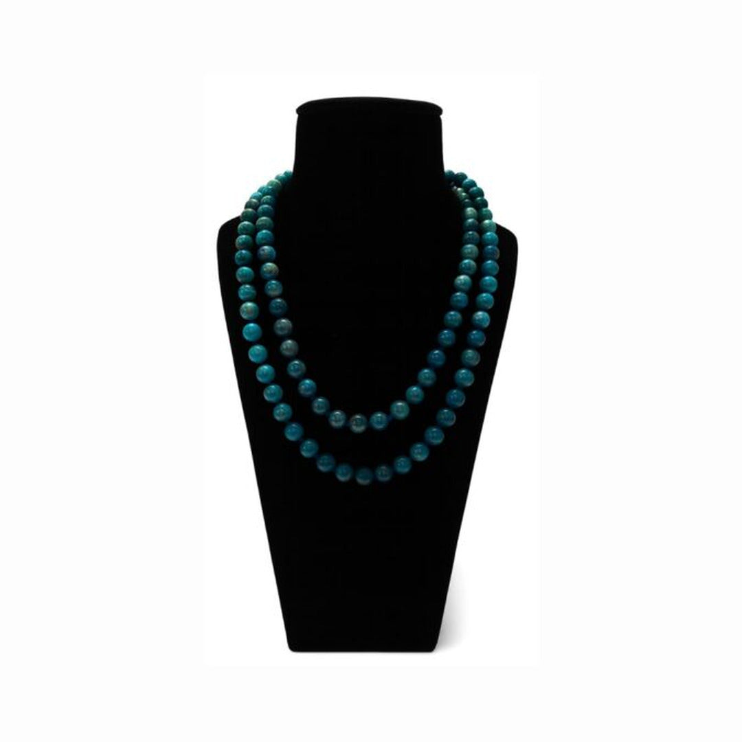 Apatite beaded mala in teal blue round beads, shown doubled on a black velvet bust