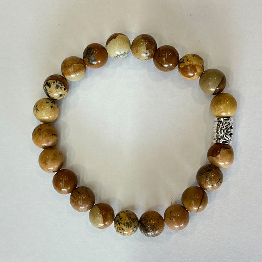Earth tone beaded bracelet in tan and brown patterned stone beads with a single silver-tone barrel spacer