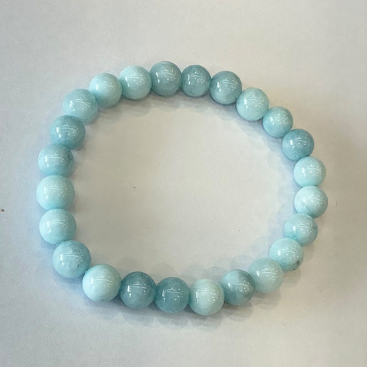 Beaded bracelet made of pale sky blue round stone beads with soft white banding