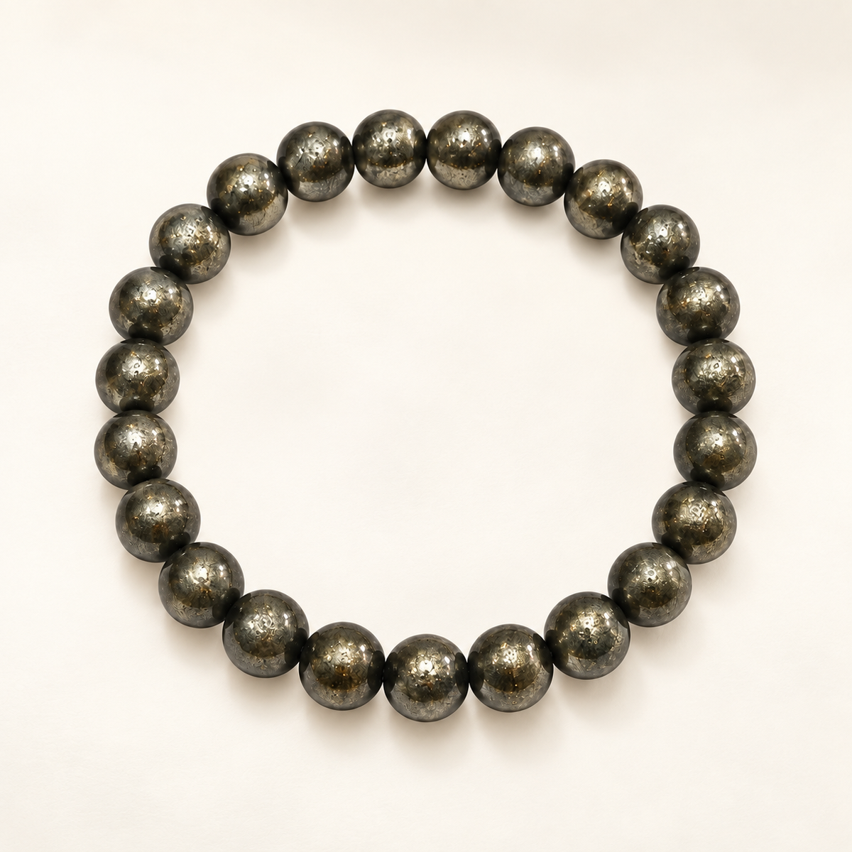 Pyrite Prosperity & Protection Bracelet — polished metallic pyrite beads on an ivory background